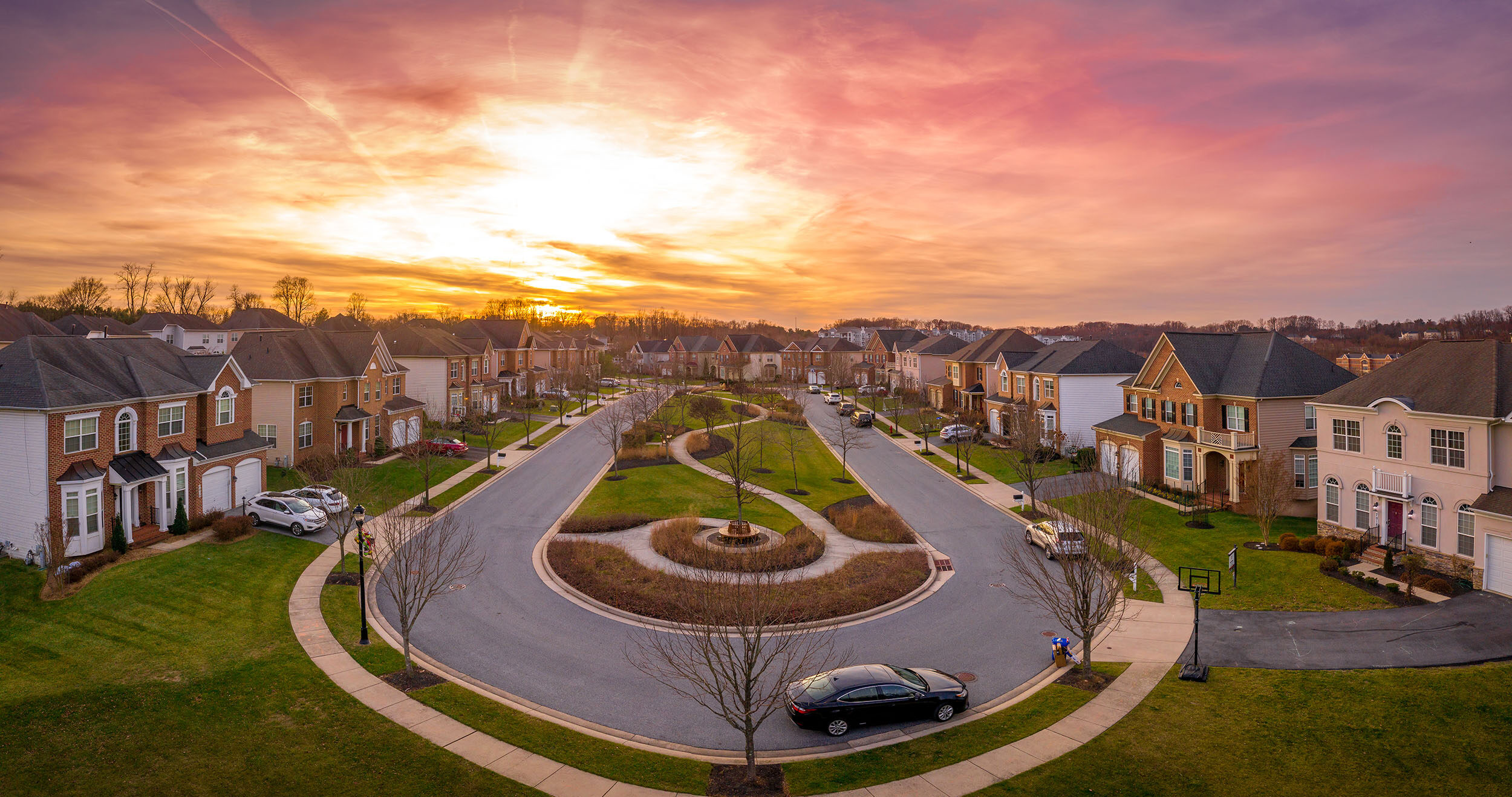 Aerial sunset view of luxury upscale residential neighborhood circle dead end cul de sac street
