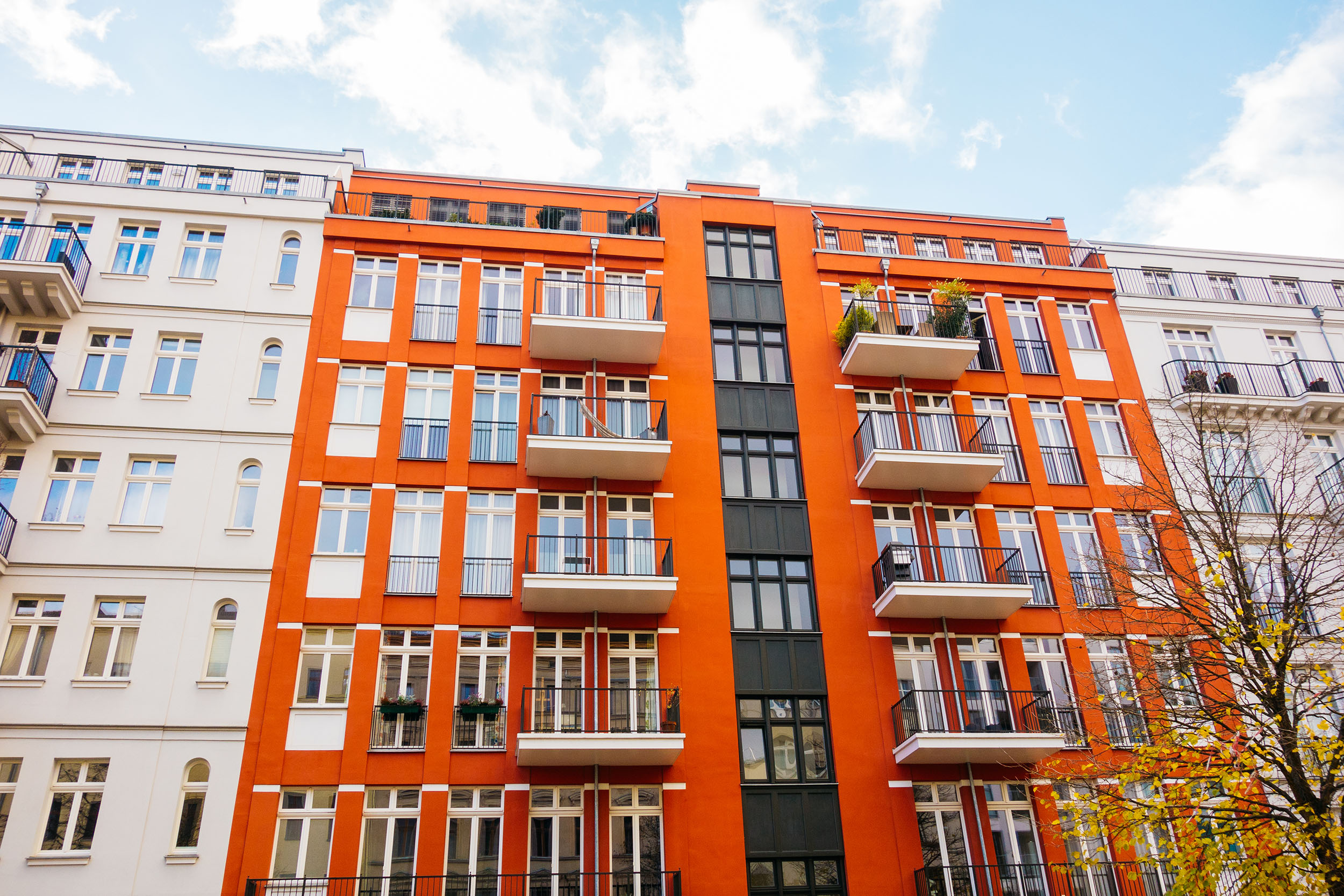 Red apartment building between white houses